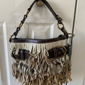 Authentic new Coach handbag. Fringy fun. Comes with dust bag and brush.